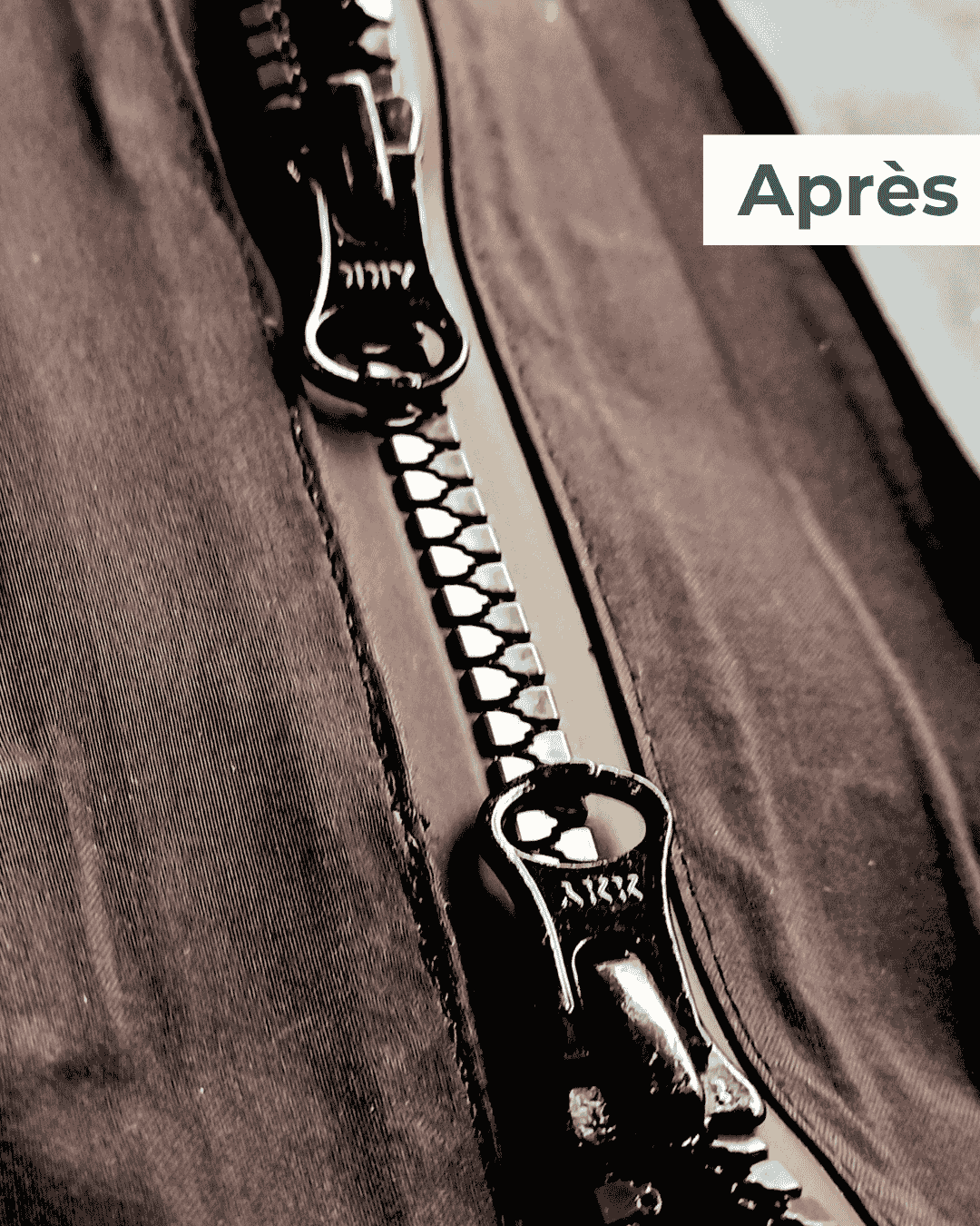 Fermeture à glissière centrale neuve installée sur une veste outdoor après réparation en atelier.