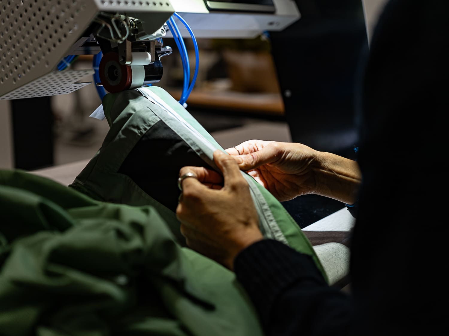 Repose de bandes étanches sur un pantalon de ski à l’aide d’une machine spécialisée dans l’atelier Goodloop.